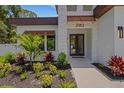 Covered front entryway with stone accents and decorative foliage at 2182 Wisteria St, Sarasota, FL 34239