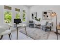Bright office space with a glass desk, comfortable seating, and natural light at 2182 Wisteria St, Sarasota, FL 34239