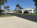Scenic street view with palm trees and charming single-story homes and well-maintained landscaping at 2218 Orange Blossom Ln # 0, Bradenton, FL 34207