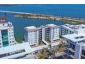 A scenic aerial view showcases the condo building's prime waterfront location and proximity to the bridge at 226 Golden Gate Pt # 63, Sarasota, FL 34236