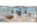 Bright living and dining areas feature large windows and beach view at 2425 Gulf Of Mexico Dr # 6A, Longboat Key, FL 34228