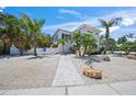 Beautiful two-story home with a white picket fence and mature landscaping at 302 And 304 Canal Rd, Sarasota, FL 34242