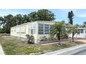 Well-maintained single-story home featuring tidy landscaping, window awnings, and a peaceful neighborhood setting at 3318 Oakwood S Blvd, Sarasota, FL 34237