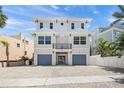 Lovely two-story house, light exterior, a small balcony, and a two-car garage at 340 Avenida De Mayo, Sarasota, FL 34242