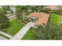 Aerial view of a single-story home on a corner lot with mature landscaping and a tile roof at 385 165Th Ne Ct, Bradenton, FL 34212