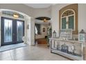 Welcoming foyer with decorative tile flooring, an arched doorway, and an accent table at 385 165Th Ne Ct, Bradenton, FL 34212