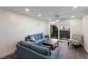 Bright living room featuring contemporary furniture, modern ceiling fan, and glass doors to the outside balcony at 4200 Gulf Dr # 104, Holmes Beach, FL 34217
