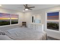 Bright main bedroom features large windows with gorgeous ocean views, tile floors, and crisp white furniture at 4200 Gulf Dr # 104, Holmes Beach, FL 34217