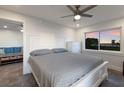 Bright main bedroom adjacent to the living room with crisp white furniture, tile floors, and ocean views at 4200 Gulf Dr # 104, Holmes Beach, FL 34217