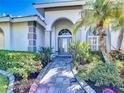 Inviting home entrance with beautiful walkway and lush landscaping at 4239 Corso Venetia Blvd, Venice, FL 34293