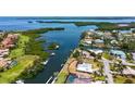 Waterfront home with direct boating access to the Gulf of Mexico, lush landscaping, and a screened pool at 4361 Pompano Ln, Palmetto, FL 34221