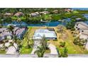 Waterfront home with a metal roof featuring direct boating access, lush landscaping, and expansive yard at 4361 Pompano Ln, Palmetto, FL 34221