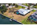 Waterfront home featuring direct boating access, screened pool, dock with boat lift and lush landscaping at 4361 Pompano Ln, Palmetto, FL 34221