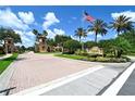 Inviting entrance to the community featuring brick pavers, landscaping, and decorative towers at 4584 Tuscana Dr, Sarasota, FL 34241