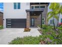 A modern exterior view with a landscaped yard showcasing the front entryway, with its clean lines and stylish design at 4726 Rivetta Ct, Sarasota, FL 34231