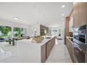 Bright, open kitchen featuring a large island, modern appliances, and a seamless flow into the living area at 4726 Rivetta Ct, Sarasota, FL 34231