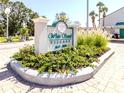 Attractive community sign for White Sands Village surrounded by lush, tropical landscaping at 5669 Midnight Pass Rd # 308, Sarasota, FL 34242