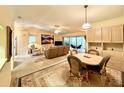 Inviting space with carpet floors, a ceiling fan, natural light, and casual dining at 5804 Garden Lakes Fern, Bradenton, FL 34203