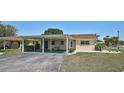 Single Gathering home featuring a carport, minimalist garden, and manicured lawn at 602 Park Cir, Bradenton, FL 34207