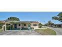 A charming one-story home featuring a carport, green lawn, and minimalist landscaping at 602 Park Cir, Bradenton, FL 34207