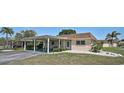 Charming home boasts a covered carport, a well-kept lawn, and minimalist front landscaping at 602 Park Cir, Bradenton, FL 34207