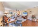 Bright and inviting living room boasts hardwood floors, comfortable seating, and seamless access to other rooms at 6422 Auburn Ave, Bradenton, FL 34207