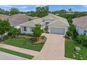 A beautifully landscaped single-Gathering home boasts a paver driveway and a well-maintained lawn at 7717 Sandhill Lake Dr, Sarasota, FL 34241
