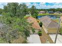 Aerial view of a home, showing the rooftop and a serene pond nearby at 7885 Bristol Park Dr, Apollo Beach, FL 33572