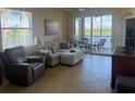 Cozy living room with comfortable seating and a view of the screened lanai at 7911 Grand Estuary Trl # 201, Bradenton, FL 34212