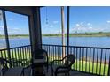 Relaxing screened patio featuring beautiful lake views and comfortable seating at 7911 Grand Estuary Trl # 201, Bradenton, FL 34212