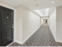 A long hallway with decorative carpet and updated lighting at 101 S Gulfstream Ave # 6C, Sarasota, FL 34236