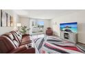 Spacious living room with neutral walls and a balcony overlooking the city at 101 S Gulfstream Ave # 6C, Sarasota, FL 34236