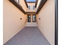 Stylish entrance with brick paved walkway, leading to double glass doors for a grand arrival at 10820 Tarflower Dr # 202, Venice, FL 34293