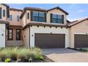 Inviting two-story home with dark trim, a brick driveway, and well-maintained landscaping at 10820 Tarflower Dr # 202, Venice, FL 34293