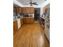 Bright and spacious kitchen with wooden cabinets, modern appliances, and hardwood floors at 1212 Candlewood Dr, Lakeland, FL 33813
