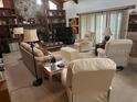 Comfortable living room featuring a stone fireplace, built-in shelving, and plush seating arrangement at 1212 Candlewood Dr, Lakeland, FL 33813
