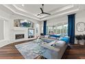 Bright living room with fireplace, large windows, and stylish furniture at 13115 Harriers Pl, Bradenton, FL 34212
