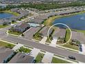 Aerial view of the home in its neighborhood near a lake with fountain and community pool at 13915 Mount Laurel Trl, Bradenton, FL 34211