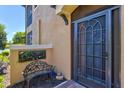 Cozy front entrance features a screened door, seating and colorful plants at 23528 Awabuki Dr # 101, Venice, FL 34293