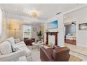 Inviting living room with a decorative fireplace, white sofa, and elegant decor at 2646 Martin St, Sarasota, FL 34237