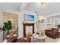 Cozy living room featuring a fireplace, glass block wall and comfortable seating at 2646 Martin St, Sarasota, FL 34237