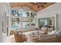 Bright sunroom featuring large windows, tile flooring, and comfortable seating arrangement at 2646 Martin St, Sarasota, FL 34237