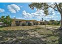Street view of a cozy single story house with a lawn, blue skies and curb appeal at 2708 27Th Avenue W Dr, Bradenton, FL 34205