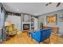 Cozy living room featuring a fireplace with white cabinets, a blue couch, and a yellow chair at 2708 27Th Avenue W Dr, Bradenton, FL 34205