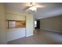 Inviting living room with tile flooring, open layout to kitchen, and a ceiling fan at 2729 Hidden Lake Blvd # D, Sarasota, FL 34237