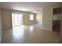 Bright living room featuring tile floors, a ceiling fan, and sliding glass doors to a balcony at 2729 Hidden Lake Blvd # D, Sarasota, FL 34237