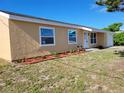 Charming single-story home with a well-manicured lawn, clean front yard, and updated windows at 354 Lasayette Ne Dr, Port Charlotte, FL 33952
