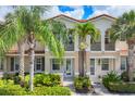 The exterior of a well-maintained townhome featuring tropical landscaping and a classic design at 3760 82Nd Avenue E Cir # 102, Sarasota, FL 34243