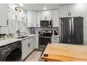 Well-lit kitchen featuring white cabinets, modern appliances, and durable countertops at 4189 Heron Way # 406E, Bradenton, FL 34205