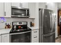 Modern kitchen featuring stainless steel appliances, white cabinets, and sleek countertops at 4189 Heron Way # 406E, Bradenton, FL 34205